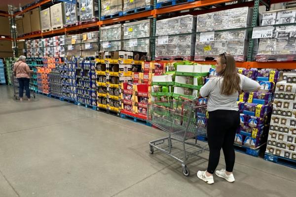 Shopper considers purchases in Costco warehouse.